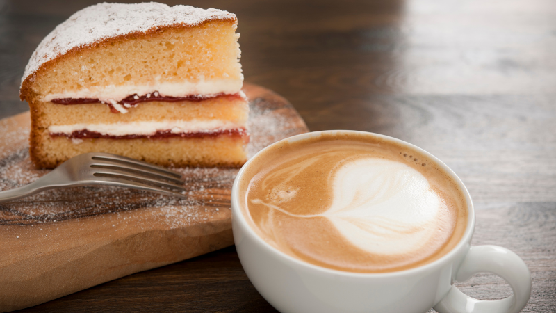 Cup coffee and a slice of cream cake